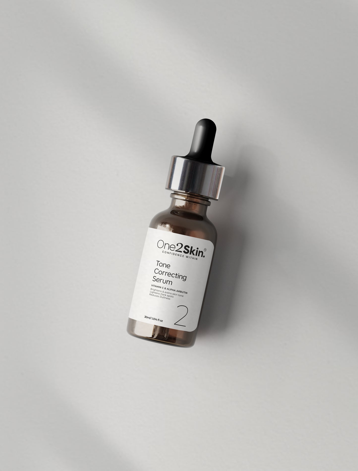 One2skin Tone correcting serum bottle with plain background
